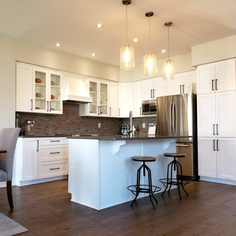 full-view-of-a-renovated-kitchen-plan-with-new-cupboards-and-mosaic-tiled-backsplash-hardwood-floor-1024x995